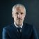 Studio portrait of a mature businessman against a dark background.